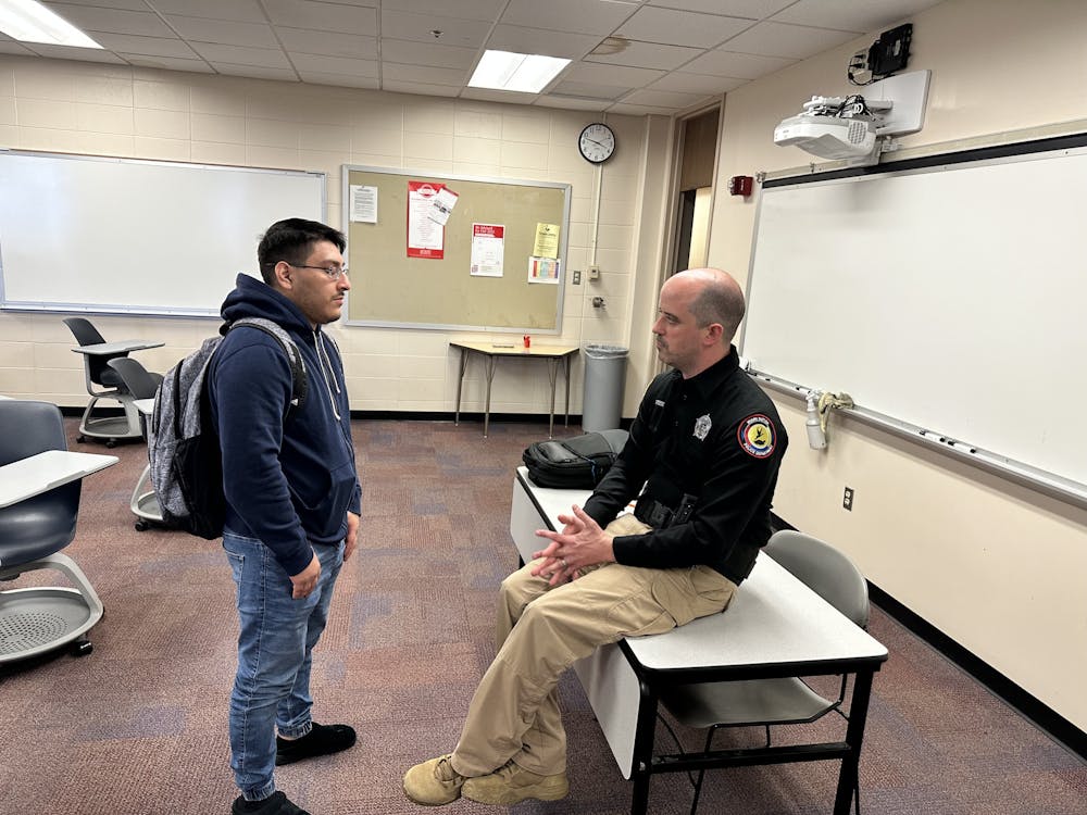A student speaks with Abel Stose, chief of police of the Miami Tribe of Oklahoma, whose visit to Oxford was sponsored by the Menard Center.