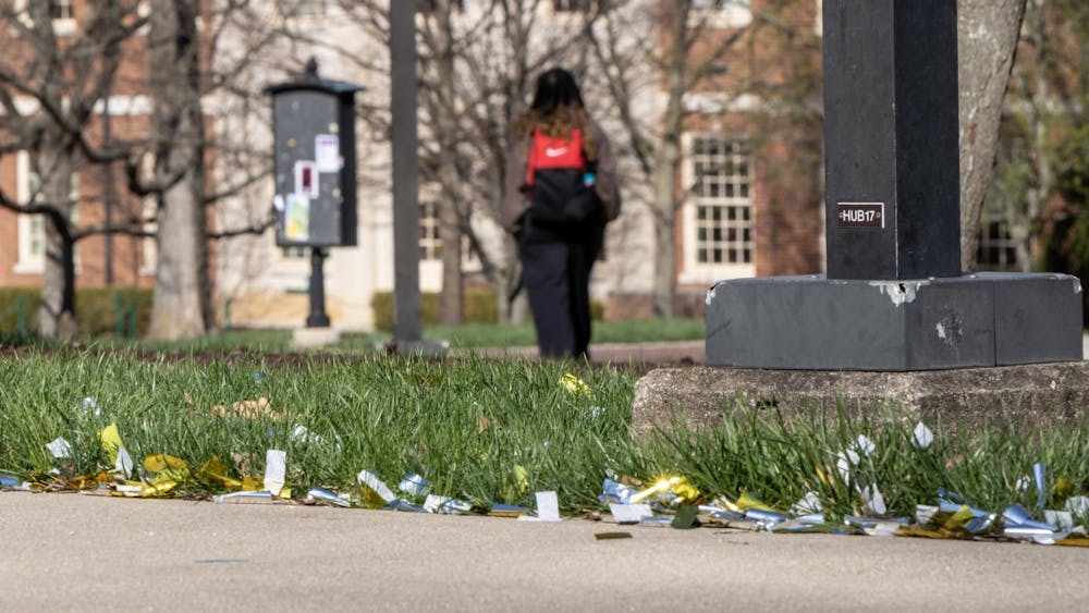 Spring brings graduation photography, which brings confetti scattered around the seal. Strong winds spread it even further around campus and Uptown.