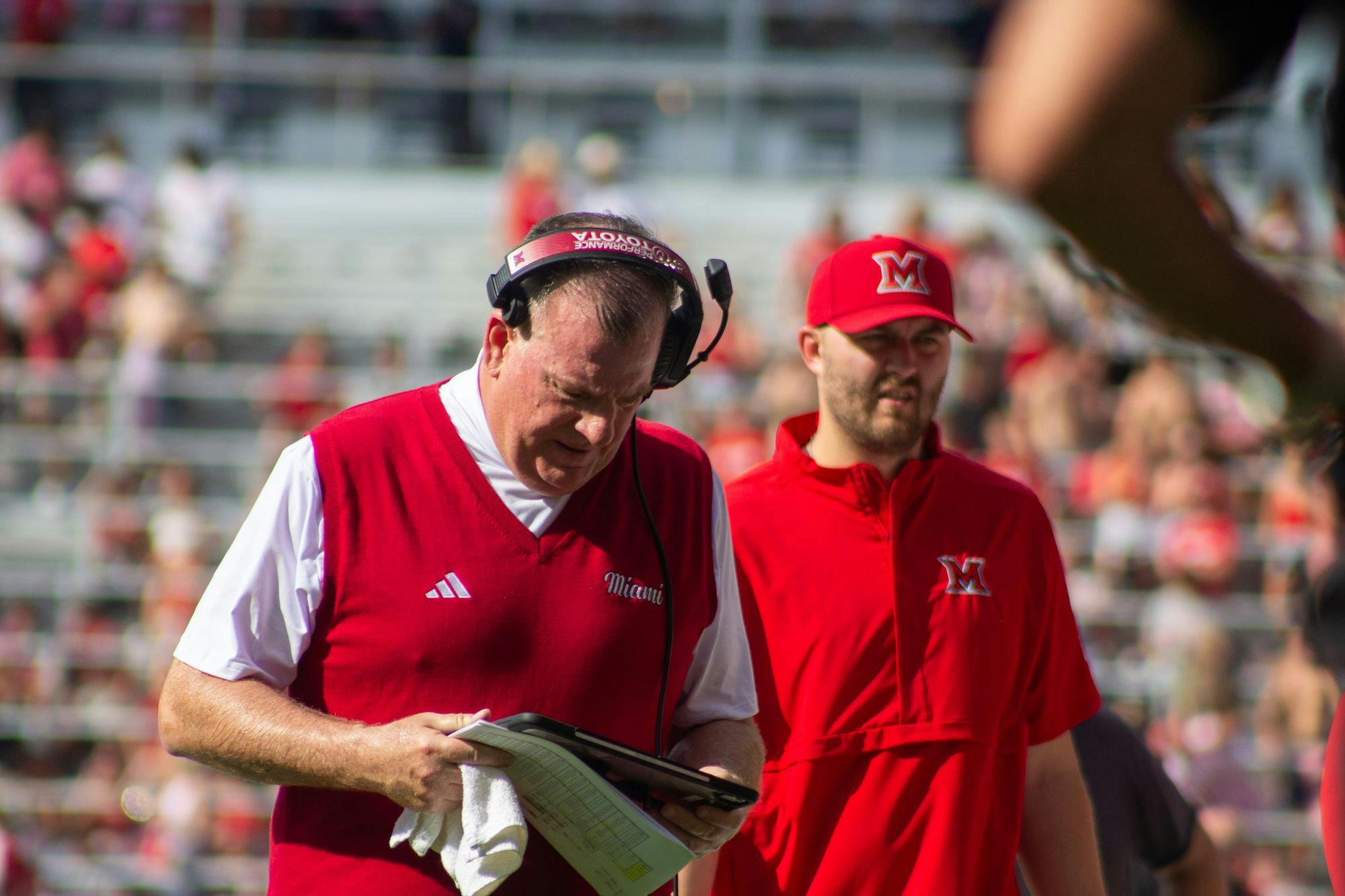 Coach Chuck Martin stands at the sideline during the Victory Bell.