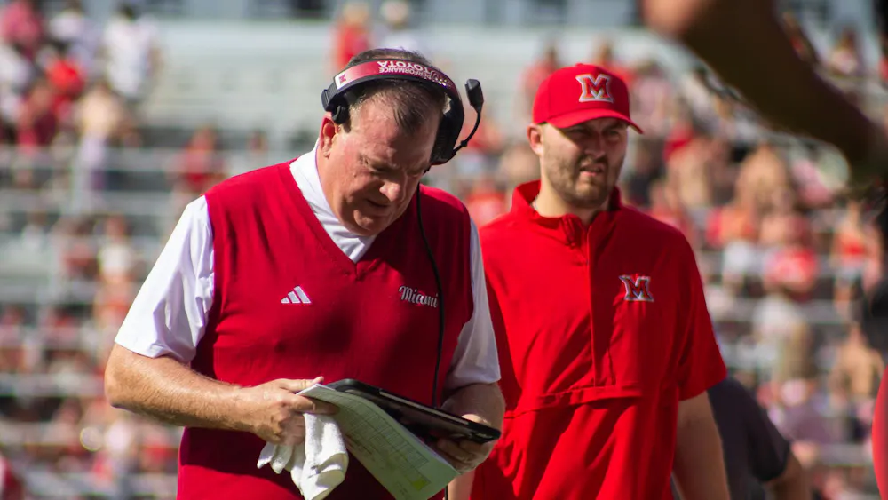 Coach Chuck Martin stands at the sideline during the Victory Bell.