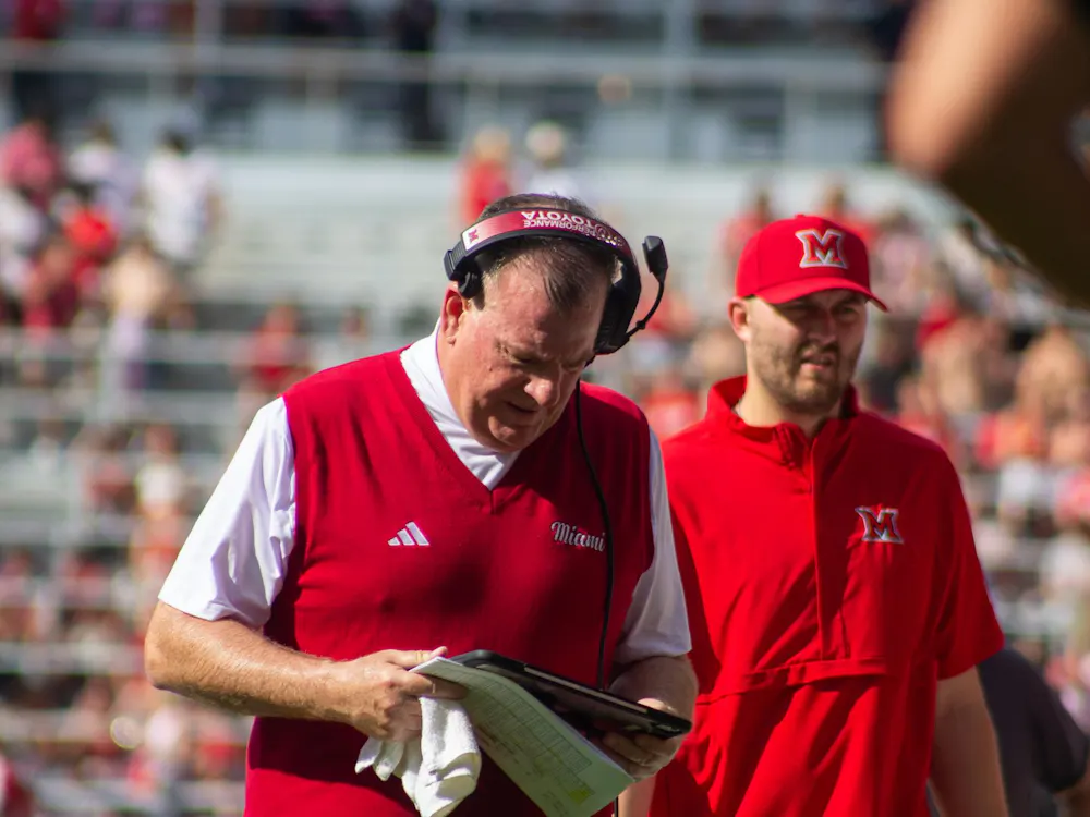 Coach Chuck Martin stands at the sideline during the Victory Bell.