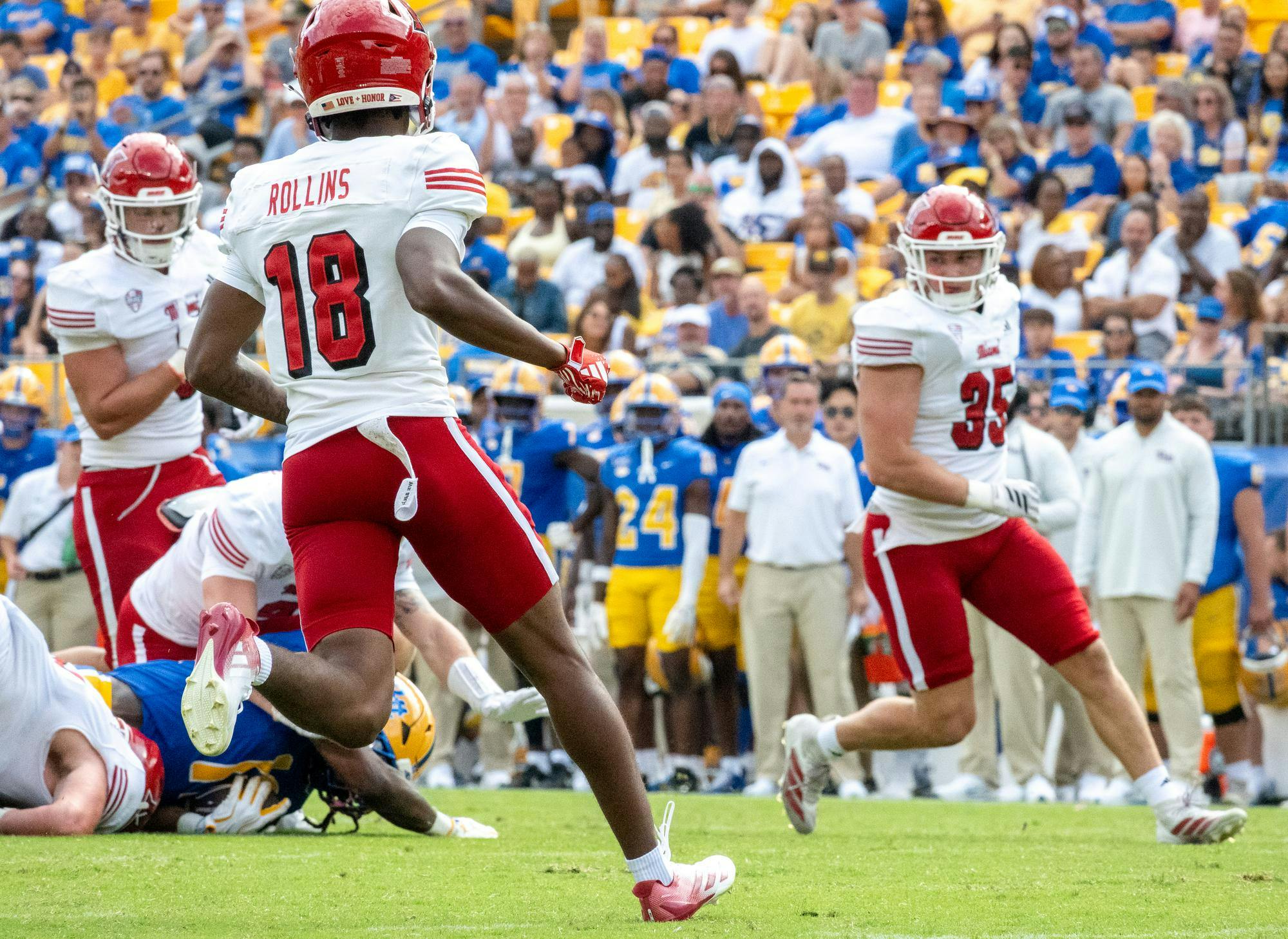 Miami football players tackle Pittsburgh player in their matchup on Saturday, Sept. 5. 