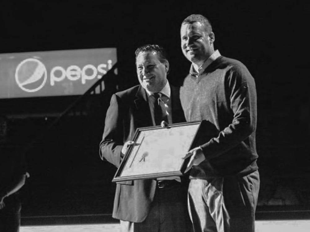 Athletic director David Sayler (left) presents Ben Roethlisberger with his Miami Athletic Hall of Fame certificate in Feb. 2013.
