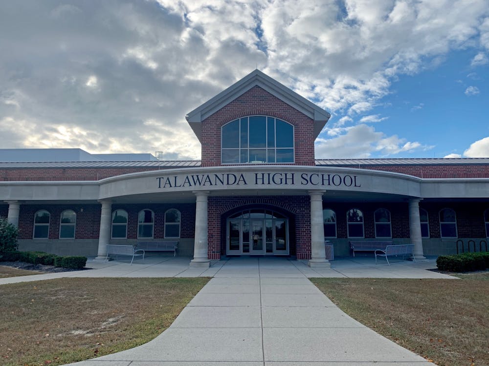 The Talawanda school board members voted on a series of cuts, reductions and fees that will yield $5.3 million the next four school years.