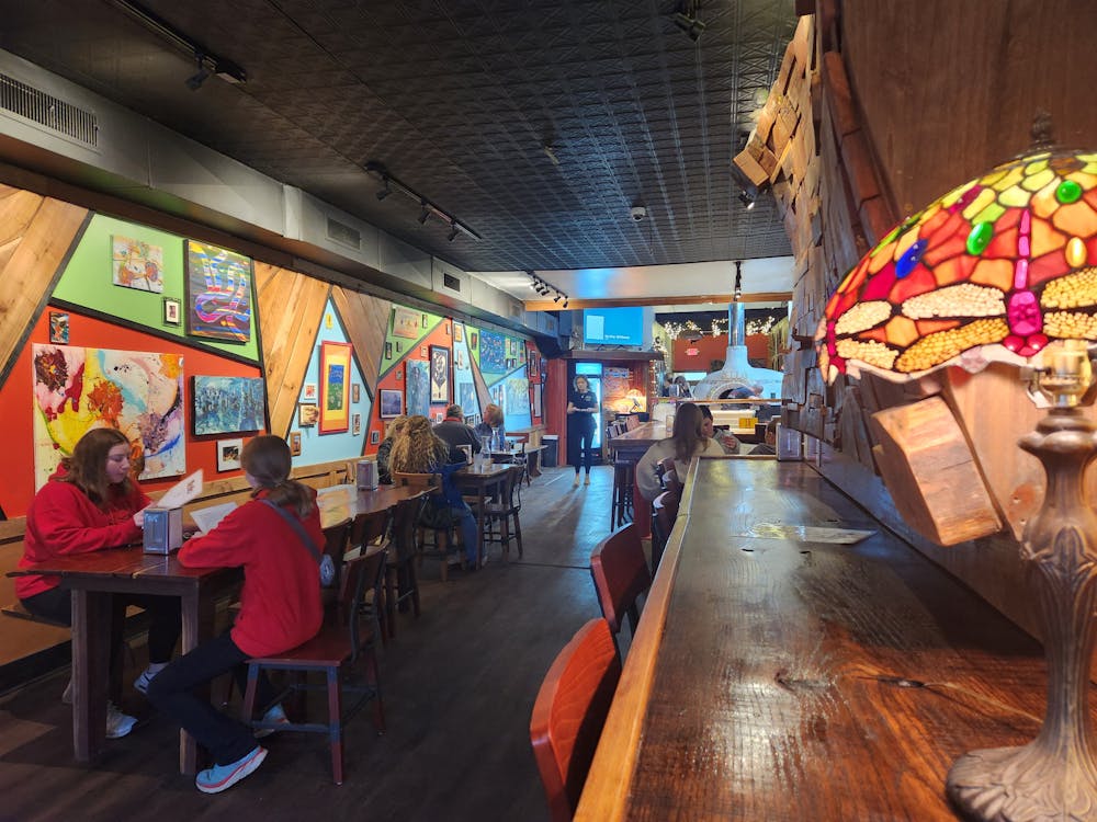 Oxford’s newest pizza restaurant offers dine-in options with multiple tables for customer and a decorated interior.