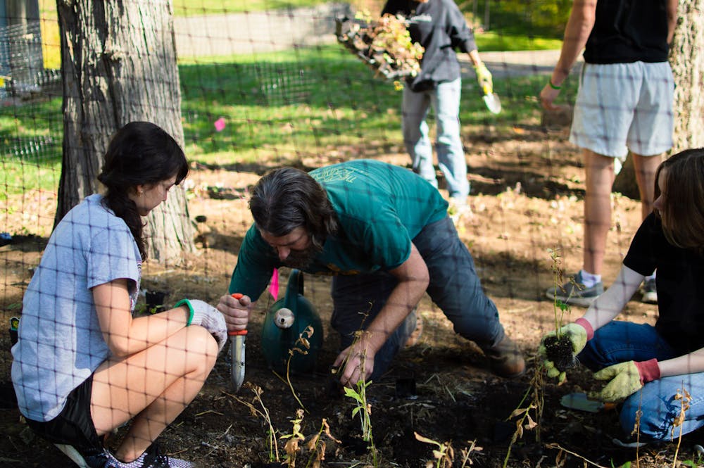 Volunteers got their hands dirty while digging the holes that the potted flowers would eventually be planted in.