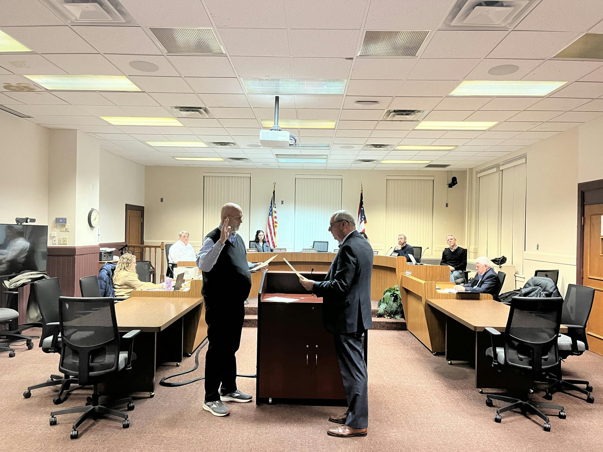 Chris Conrad, law director, swears in Oxford’s returning mayor William Snavely for another term.