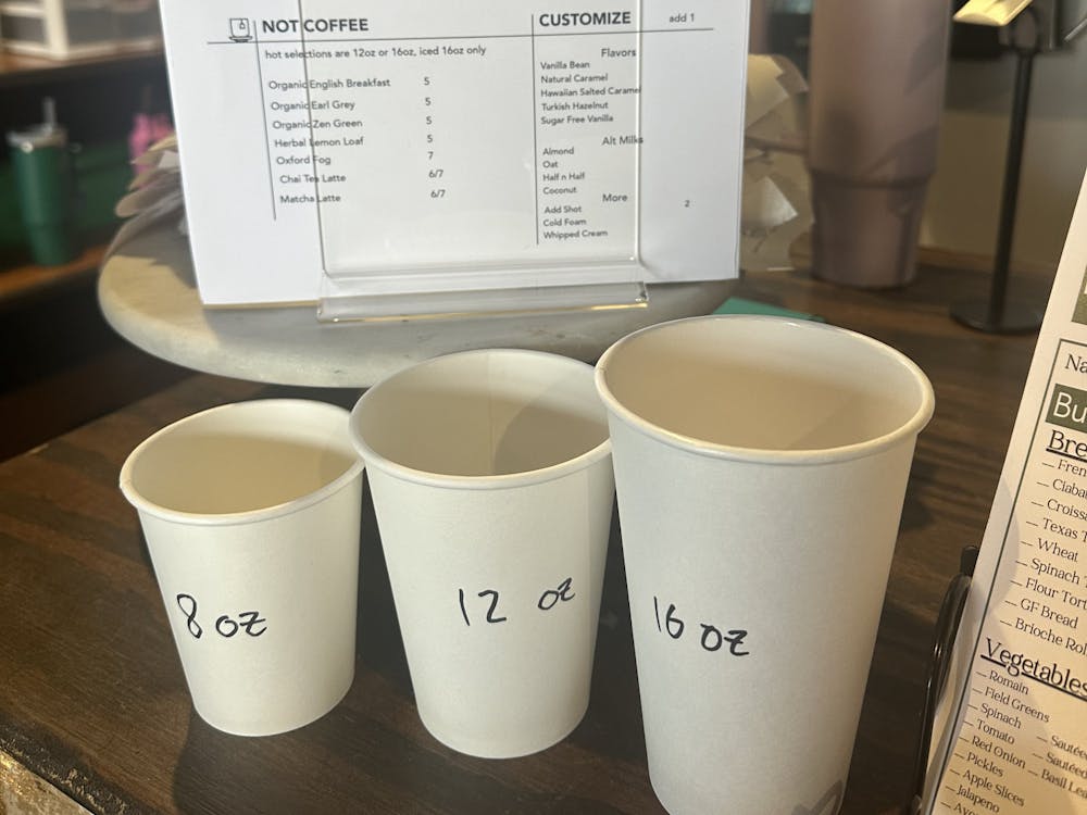 The menu for Fridge’s new espresso bar is featured at the register along with cups for reference to how big the sizes are.