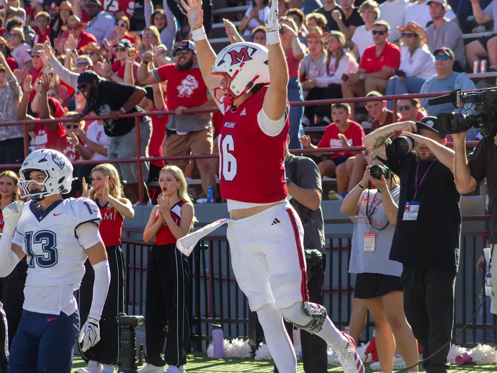 Redshirt-freshman quarterback David McComb celebrates in game against the University of Connecticut on Sept. 26.