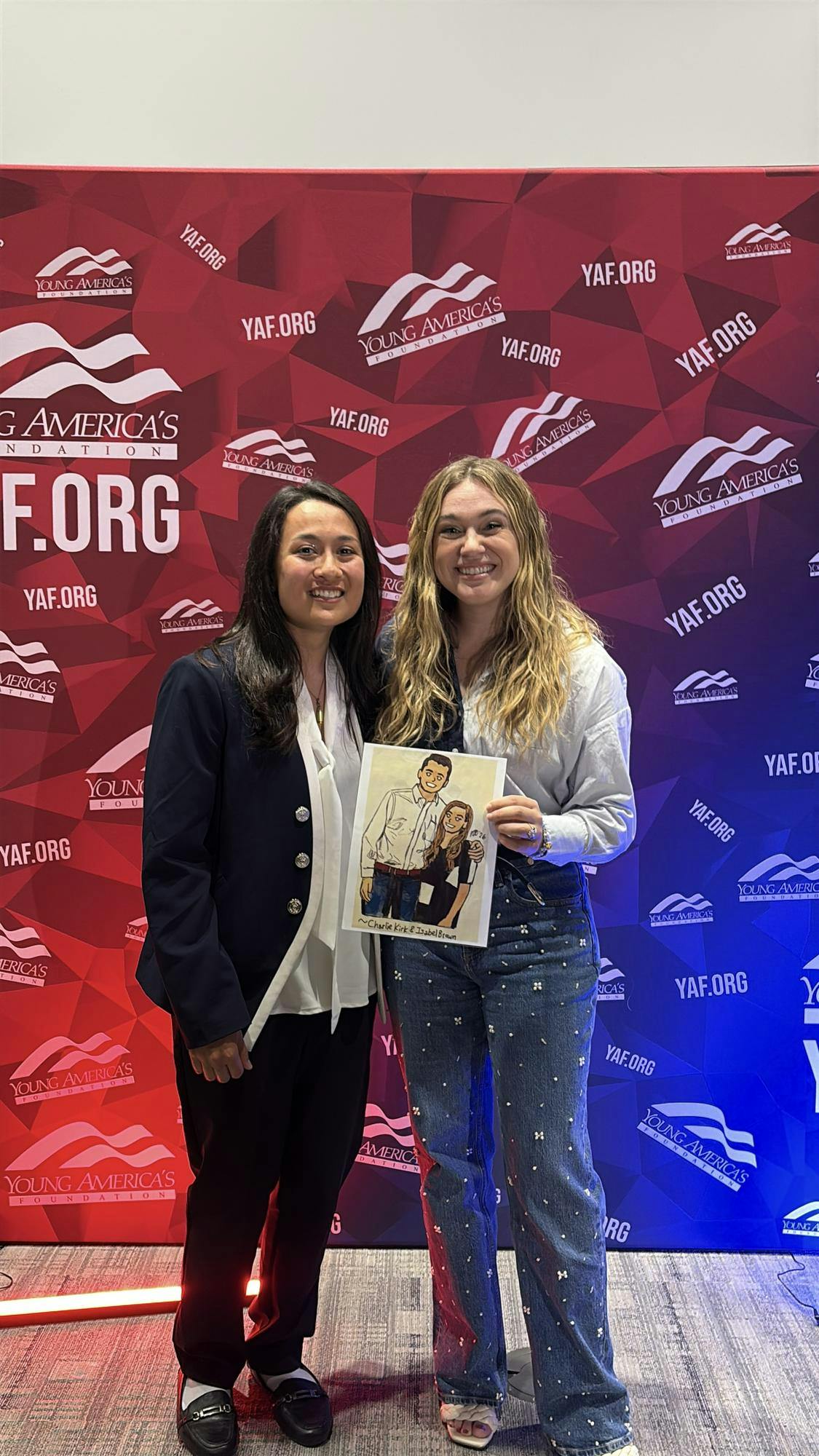 Josie Zimmerman (left) and Isabel Brown (right) with a drawing Zimmerman made of Brown and the late Charlie Kirk. Photo provided by Josie Zimmerman