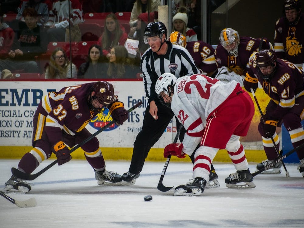 Junior forward Joe Cassetti wins a faceoff against a Minnesota-Duluth player during the team's weekend series against the Bulldogs.