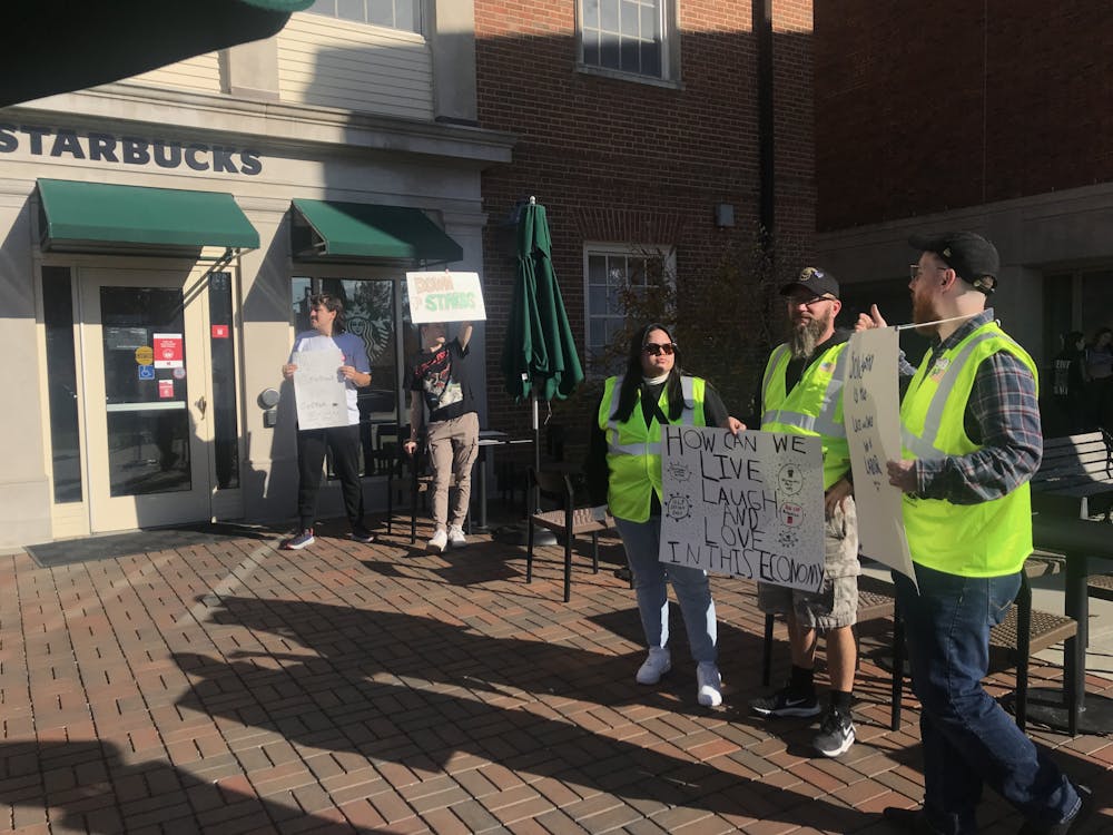 Members of Teamsters Local 100 from DHL-CVG joined students with Miami's Young Democratic Socialists of America outside Starbucks to inform customers of its unfair labor practices. 