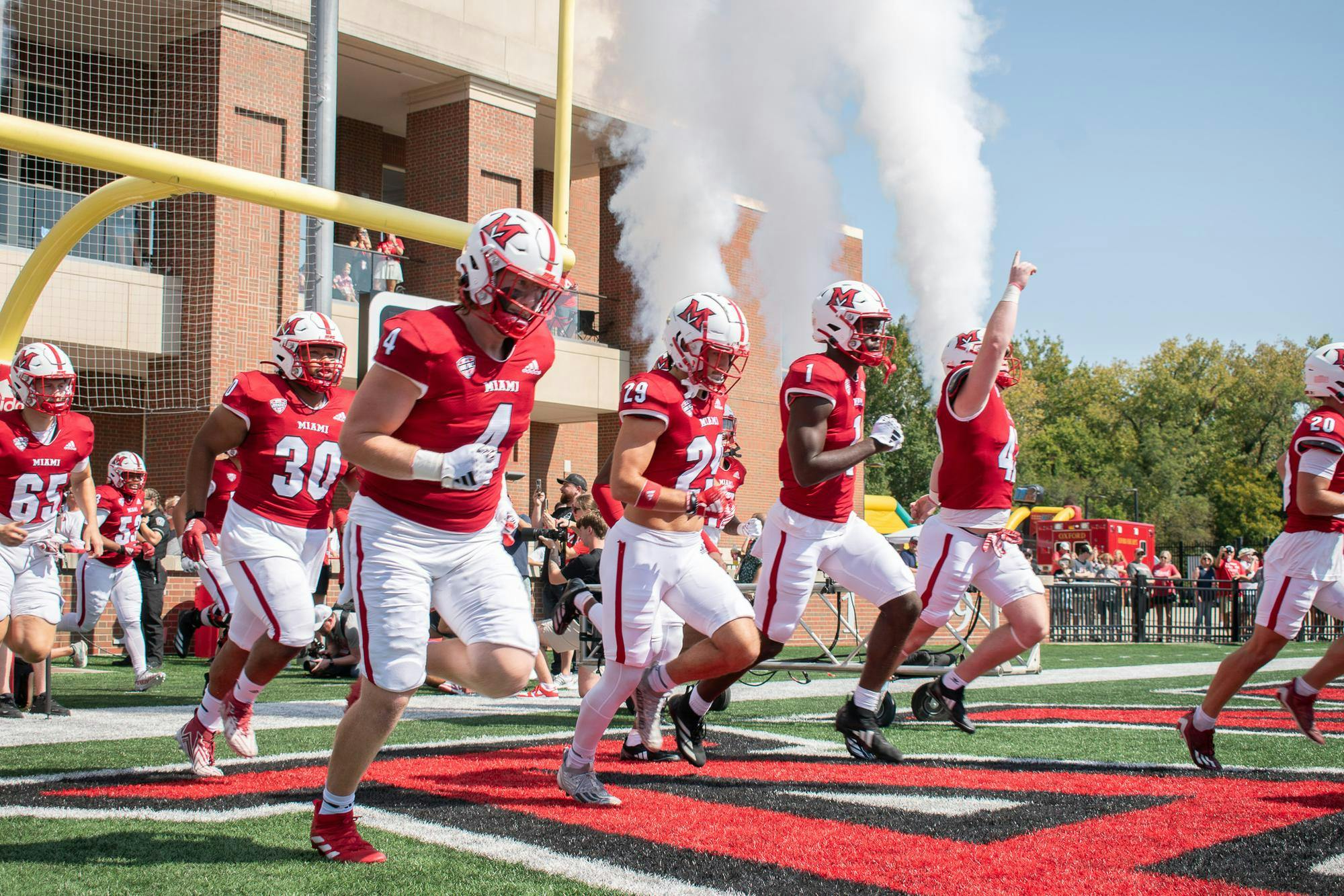 The Miami football team runs out on the field at Yager Stadium before the 2024 home opener against Cincinnati