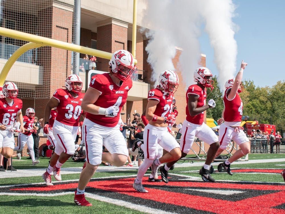 The Miami football team runs out on the field at Yager Stadium before the 2024 home opener against Cincinnati