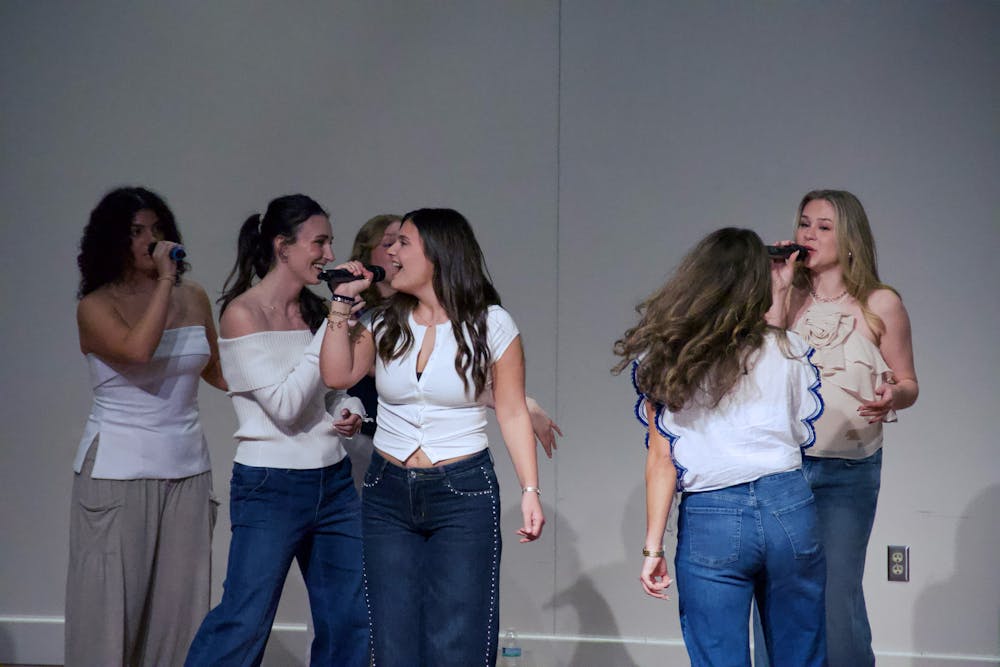 <p>Sophomore soloist, Tess Kavadas, sings Olivia Dean’s “Man I need” arranged by Mary Goodney at A Cappella All Stars Invitations Concert in March.</p>