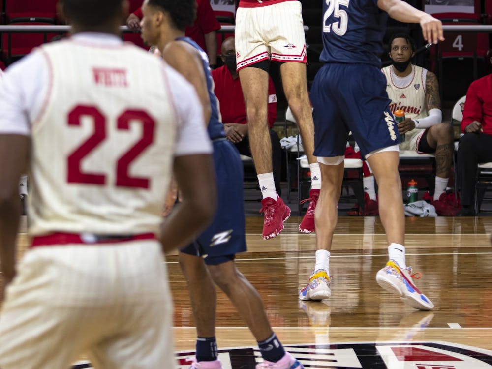 Junior forward Eli McNamara shoots a mid-range jumper over an Akron defender during an 83-76 loss on Feb. 12 at Millett Hall.