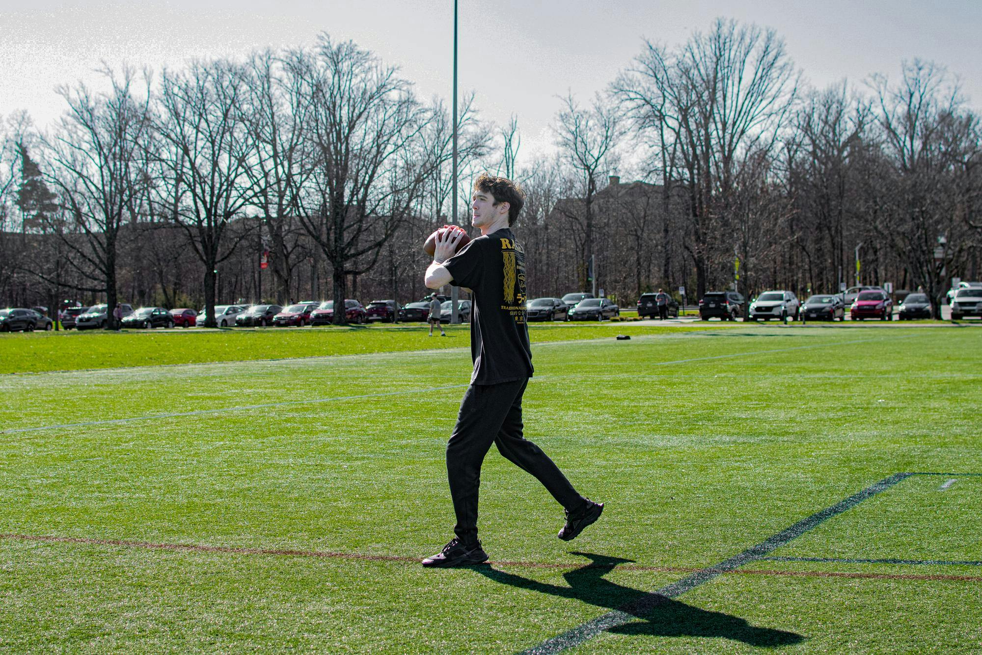 Zac Fey plays football on cook field.