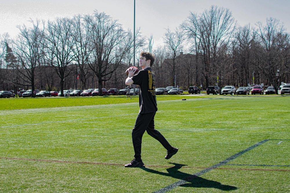 Zac Fey plays football on cook field.