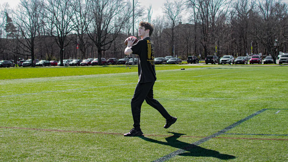 Zac Fey plays football on cook field.