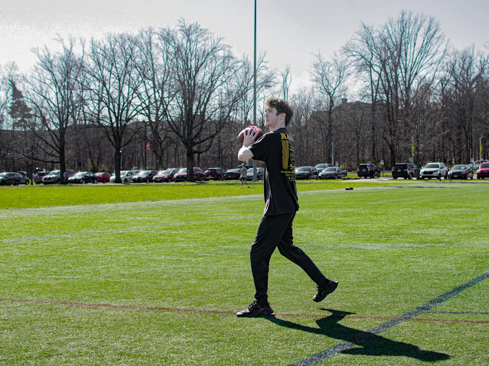 Zac Fey plays football on cook field.