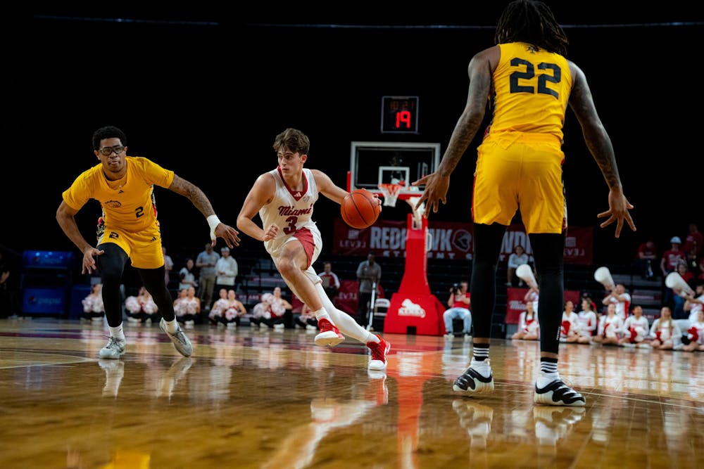 <p>Sophomore guard Luke Skaljac dribbles against the Golden Dragons at Millett Hall on Nov. 23</p>