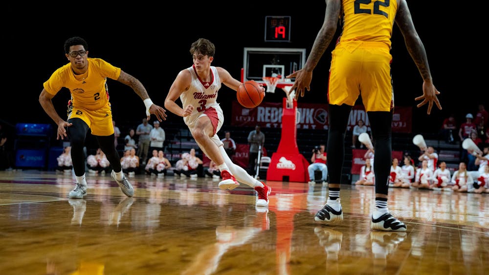 Sophomore guard Luke Skaljac dribbles against the Golden Dragons at Millett Hall on Nov. 23