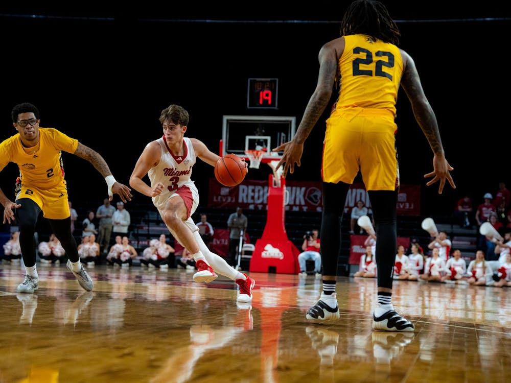 Sophomore guard Luke Skaljac dribbles against the Golden Dragons at Millett Hall on Nov. 23