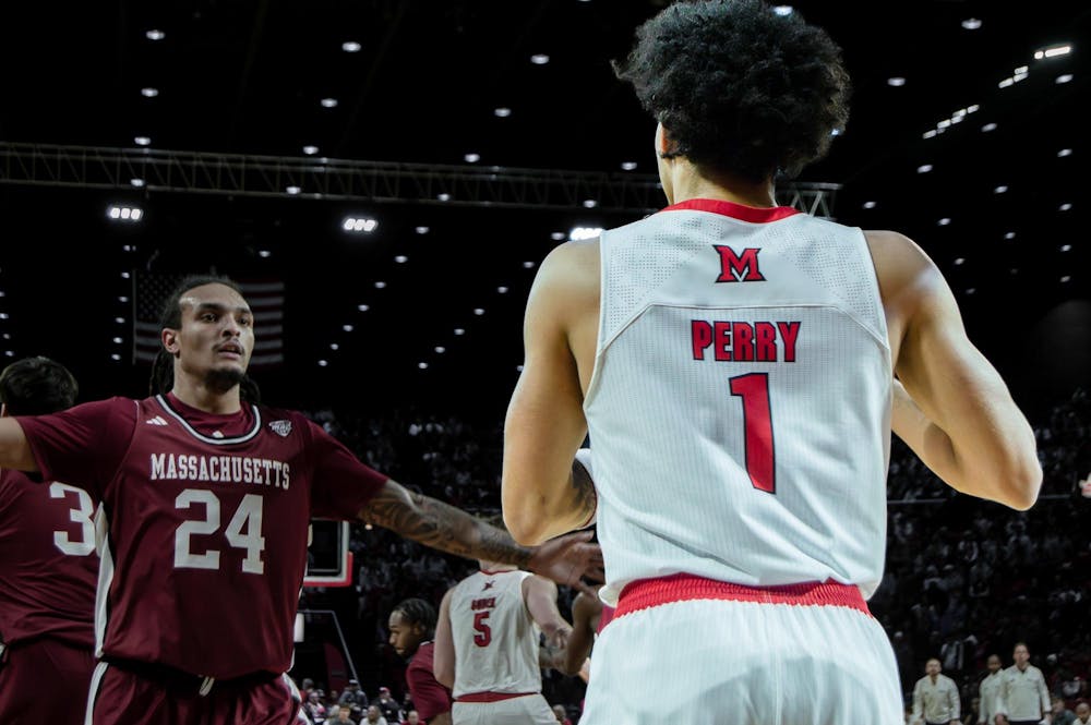 Trey Perry looks to pass the ball against UMass at Millett Hall on Jan. 27.