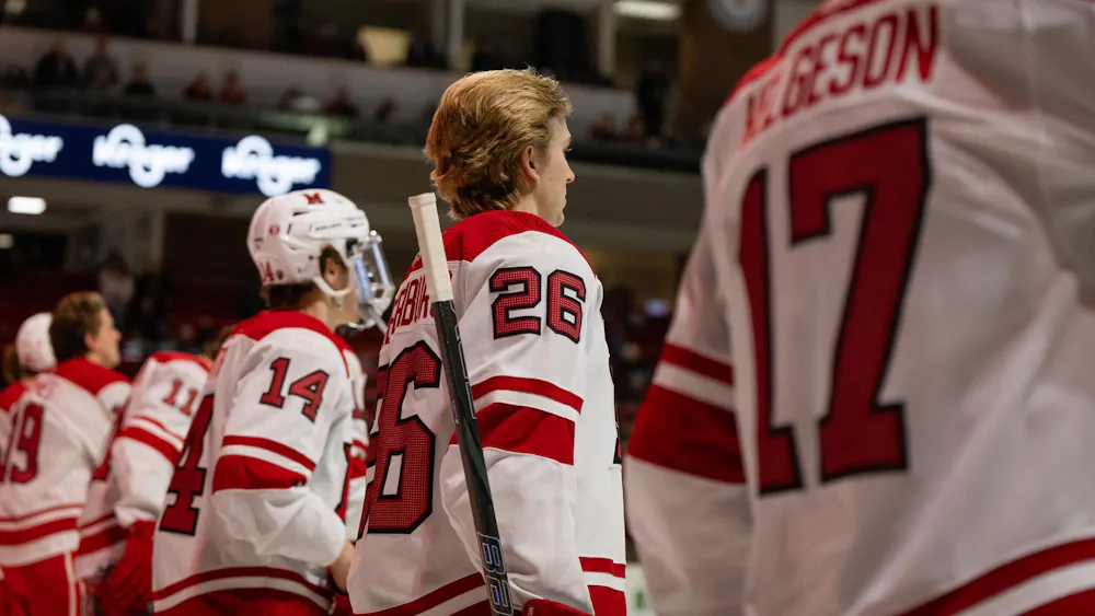Miami hockey team stands for the national anthem at beginning of game against Arizona State University.