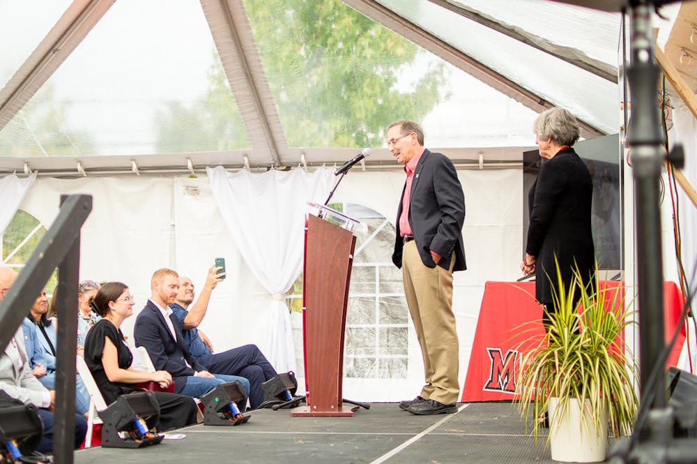 <p>Graham (left) and Sharon Mitchell (right) speak at the Flip the Switch event where their donation and plans for the solar panel sustainability park were unveiled. </p>