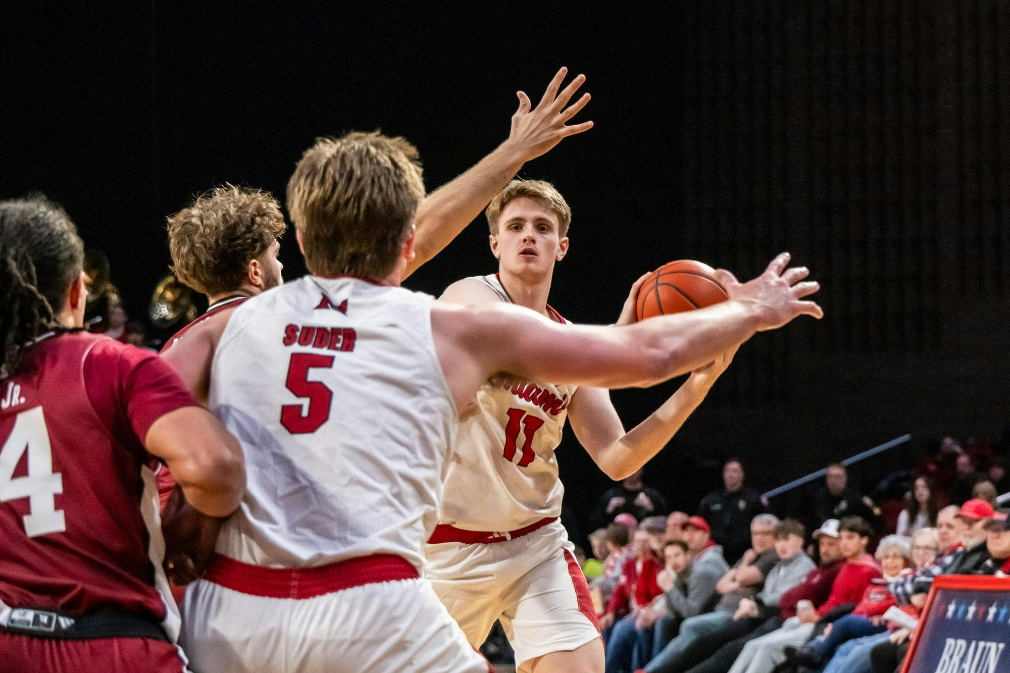 Junior forward Almar Atlason looks to pass to senior guard Peter Suder against UMass at Millett Hall on Jan. 27