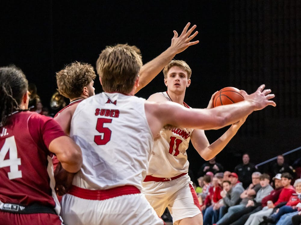 Junior forward Almar Atlason looks to pass to senior guard Peter Suder against UMass at Millett Hall on Jan. 27