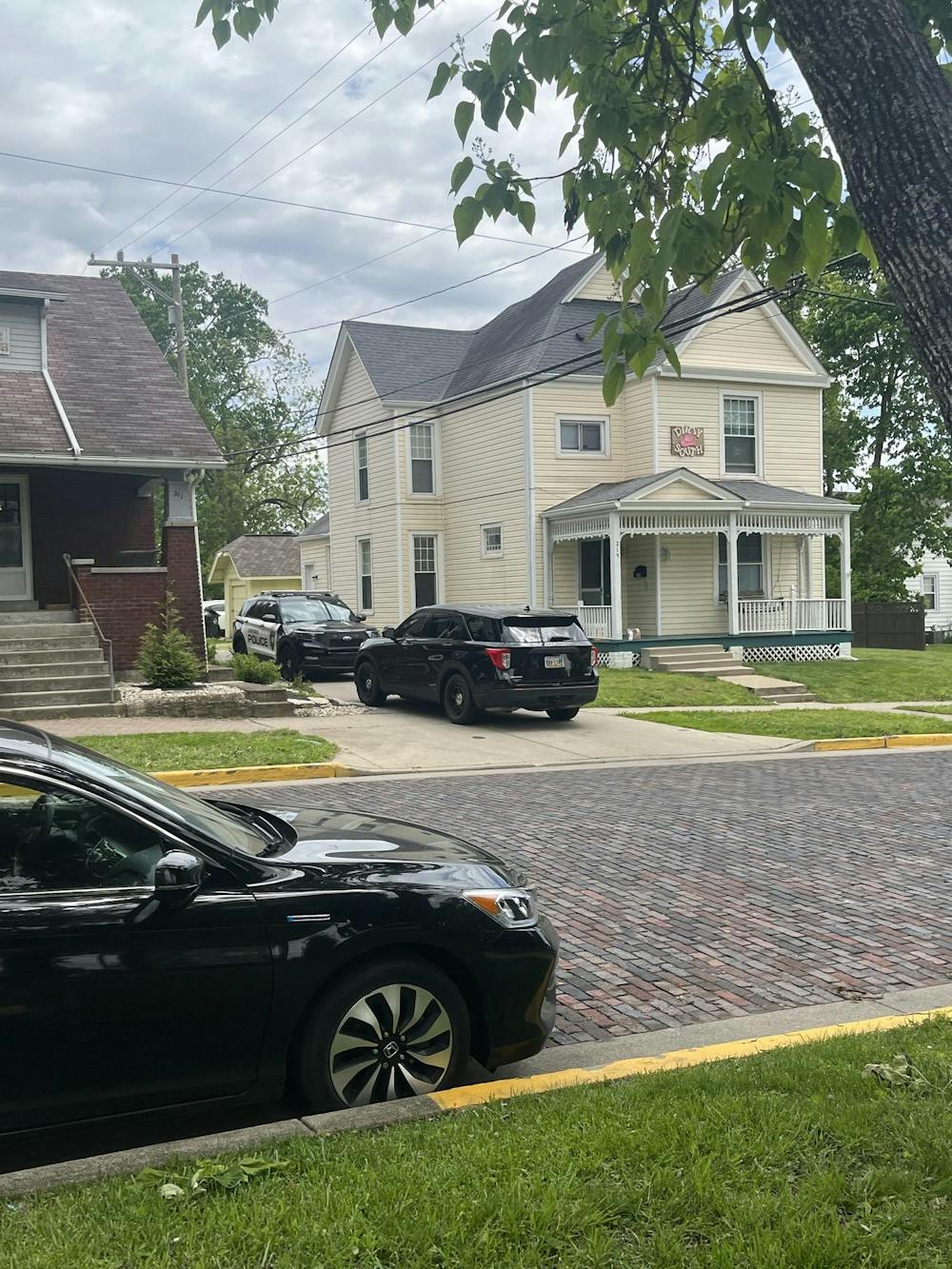 The 215 S. College Ave. house, "Dirty South," with Oxford Police parked in the driveway. 