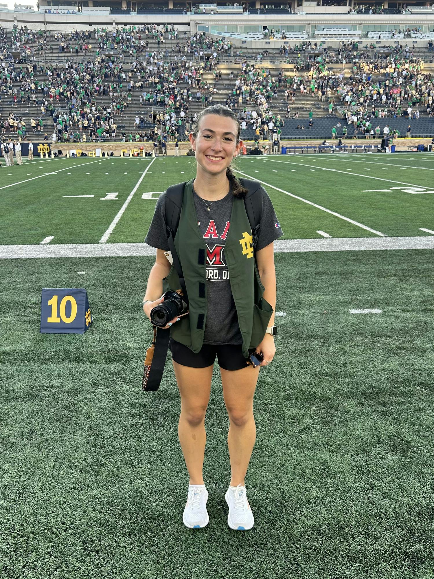 Jessica Monahan on the sideline before snapping photos as the Miami RedHawks took on Notre Dame. 