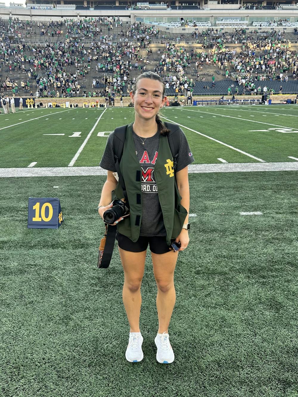 Jessica Monahan on the sideline before snapping photos as the Miami RedHawks took on Notre Dame. 