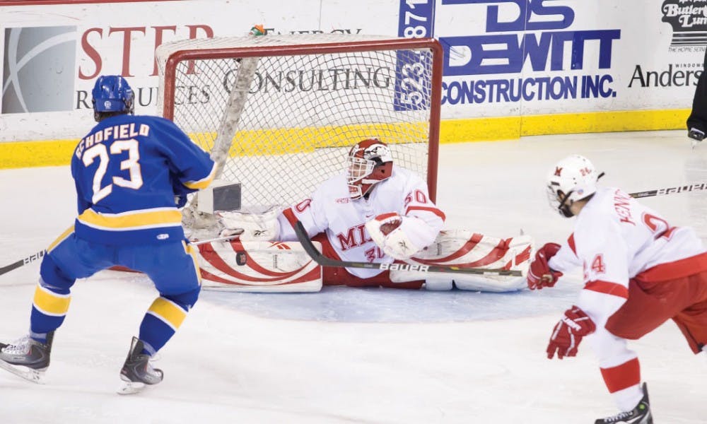 Miami netminder Cody Reichard lunges for a save Oct. 29  against Lake Superior State University. 