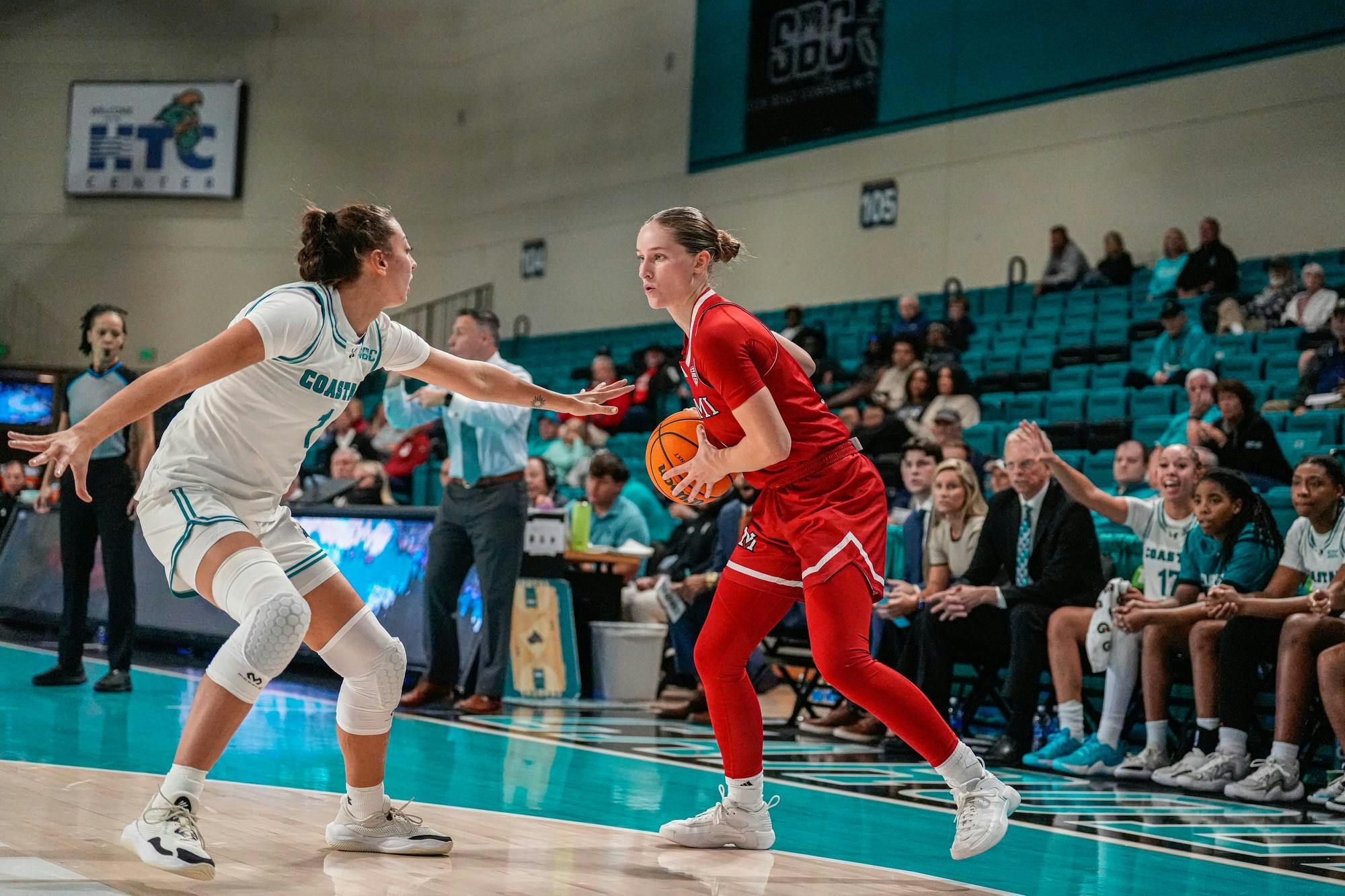 Senior guard Amber Scalia dribbles against Coastal Carolina in Monday's season-opener win for the RedHawks