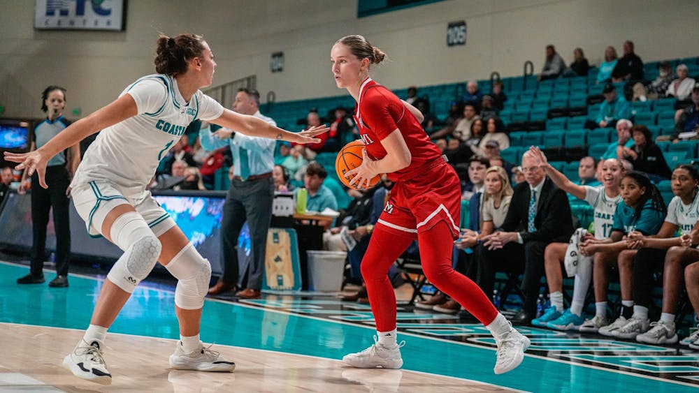 Senior guard Amber Scalia dribbles against Coastal Carolina in Monday's season-opener win for the RedHawks