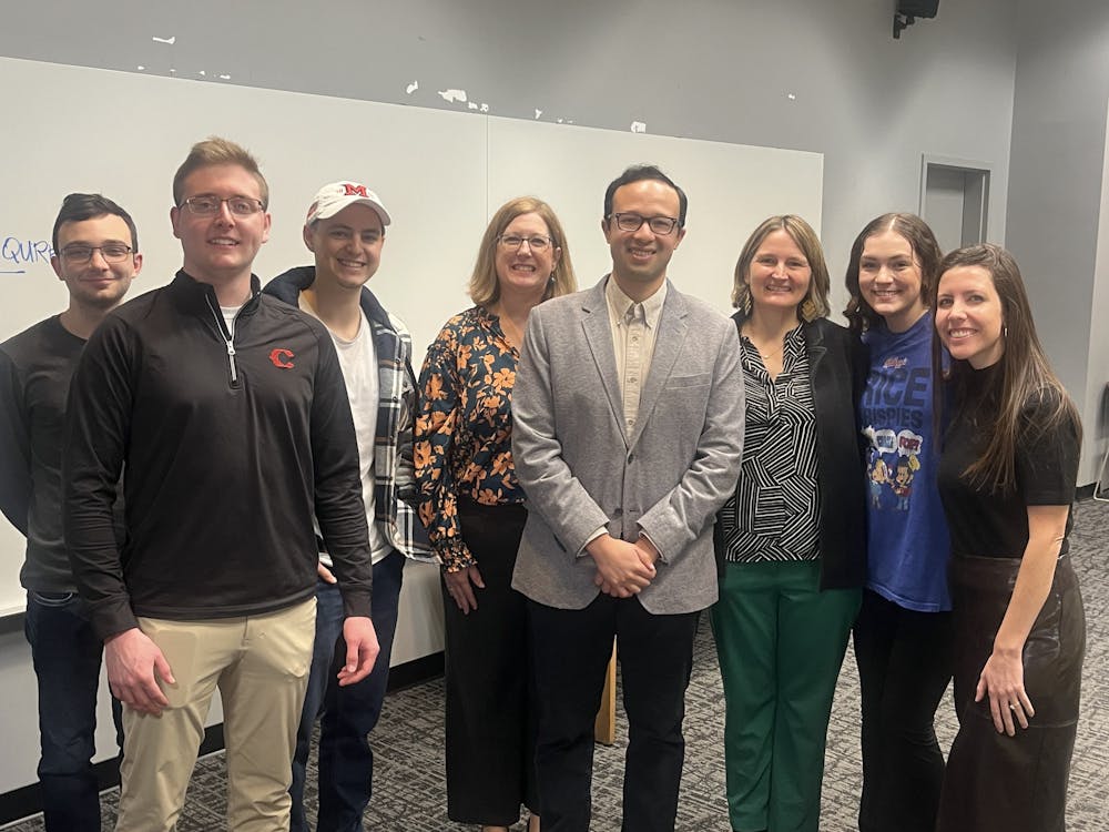 Jorge Merlos takes a photo with Miami Spanish majors on Feb. 4