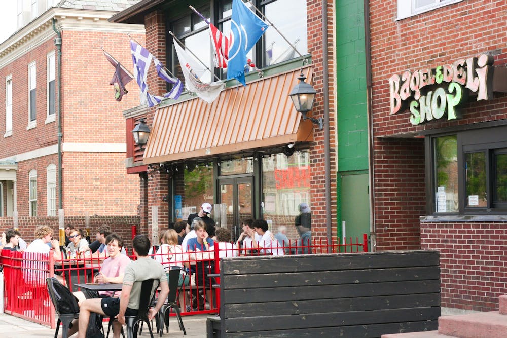 Students gather outside Bagel & Deli Shop and Skipper's Pub on West High Street.