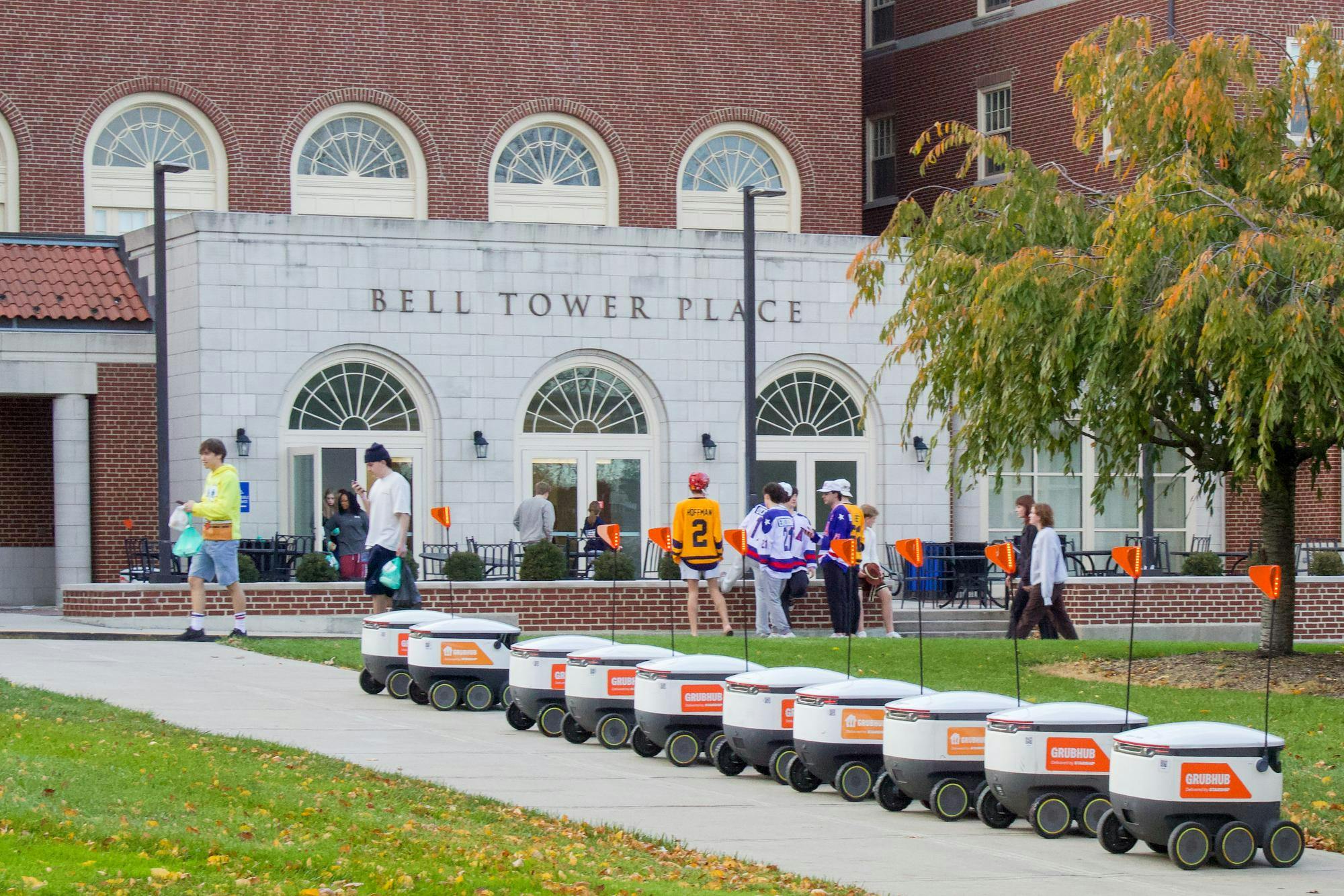 Grubhub robots sit lined up outside Bell Tower Commons.