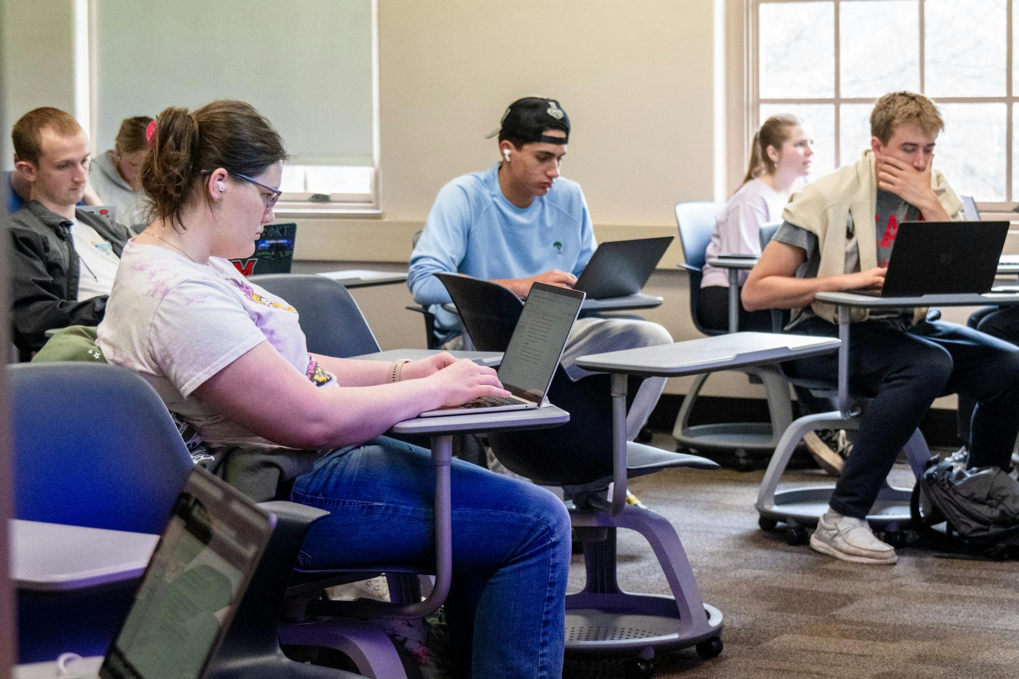 Students complete their coursework during a political science class in Harrison Hall