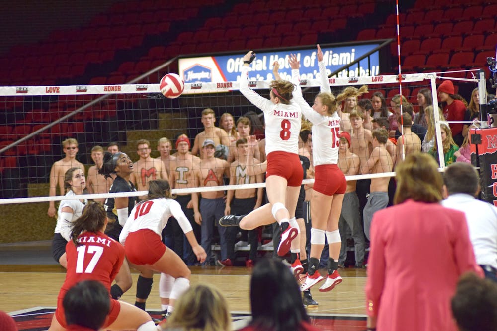 Senior middle hitter Margaret Payne and freshman outside hitter Allyson Severance combine for a block against Kent State. Miami beat the Golden Flashes, 3-0, on Nov. 2 and Millett Hall.