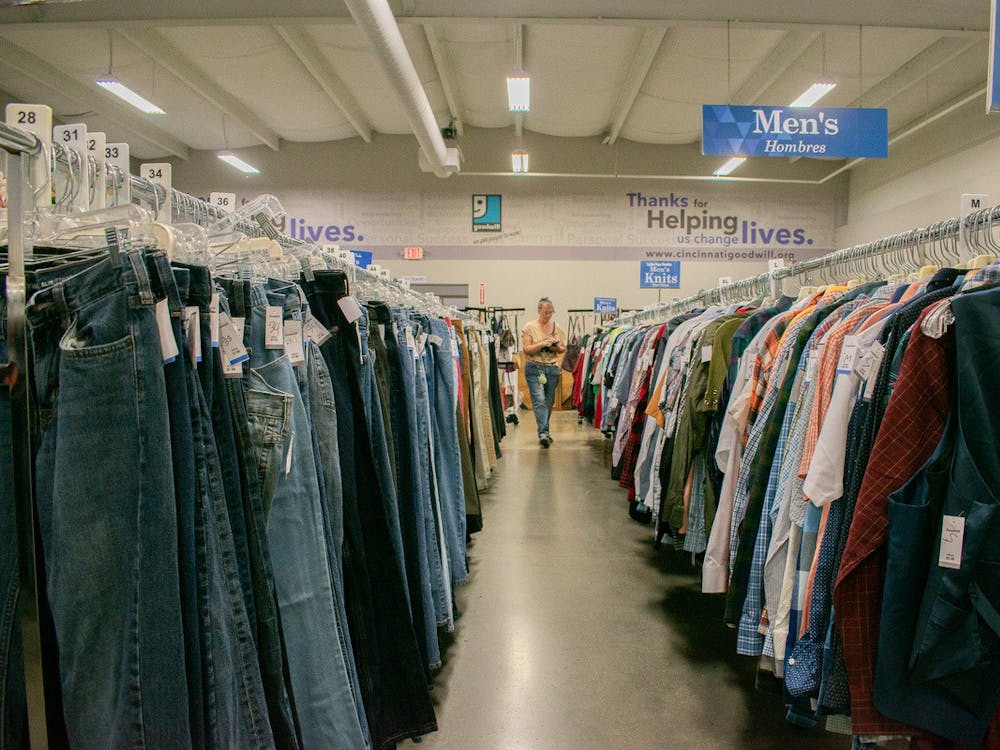 A Goodwill employee surveils her aisle.