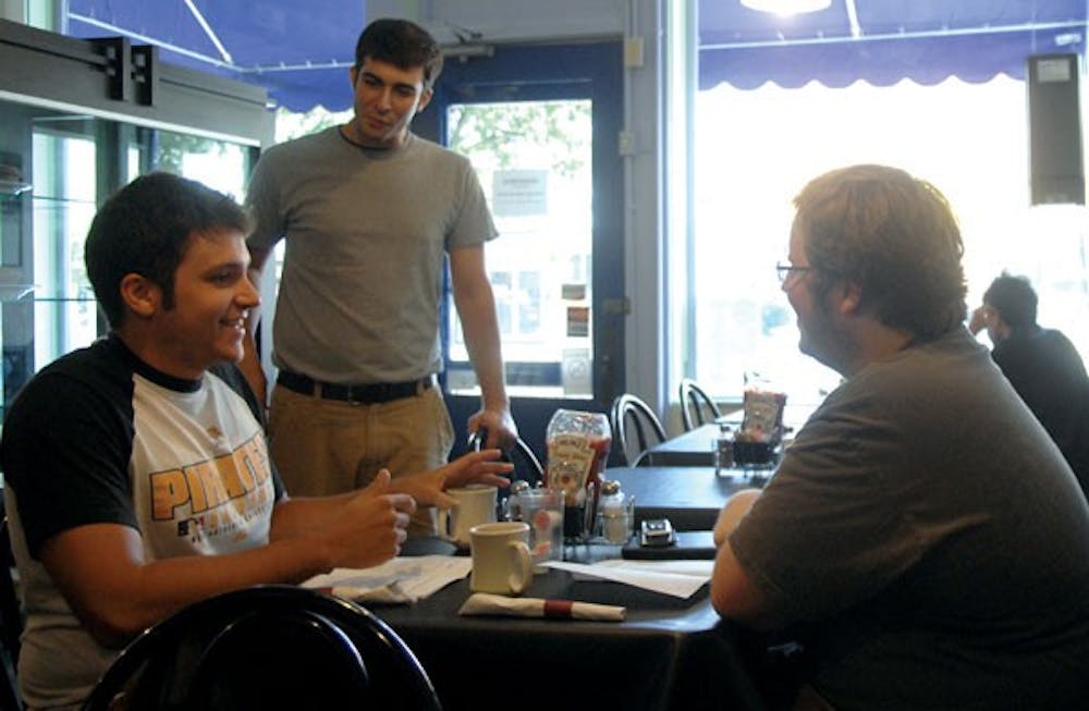 Seniors Vince Mancuso and Ben Stockwell and manager Nathan Uhl dine at the  expanding restaurant Monday. The patrons call themselves “regulars” of Morning Sun. 
