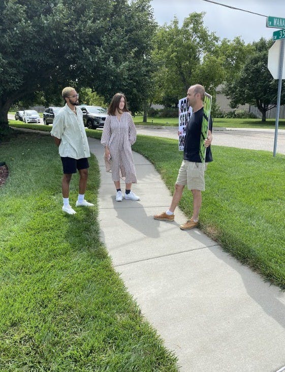 Researchers Jayson Meggysey (left) and Annalise Chapdelaine (center) speak with a member of the Westboro Baptist Church (right) at a picket.