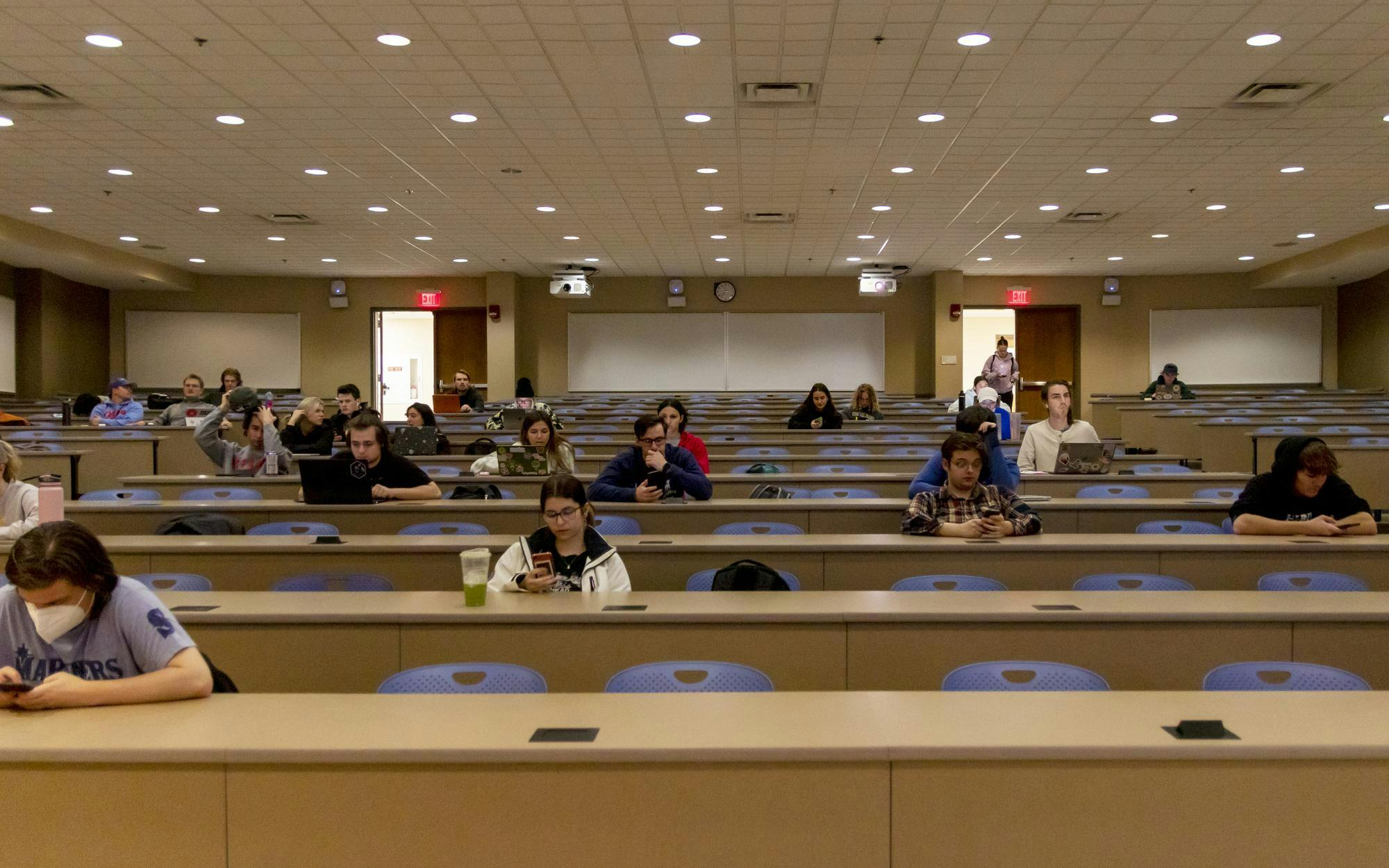  Students in a journalism class stare at their phones.