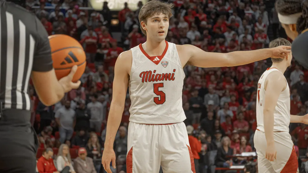 Senior guard Peter Suder directs a teammate in game against the Toledo Rockets.