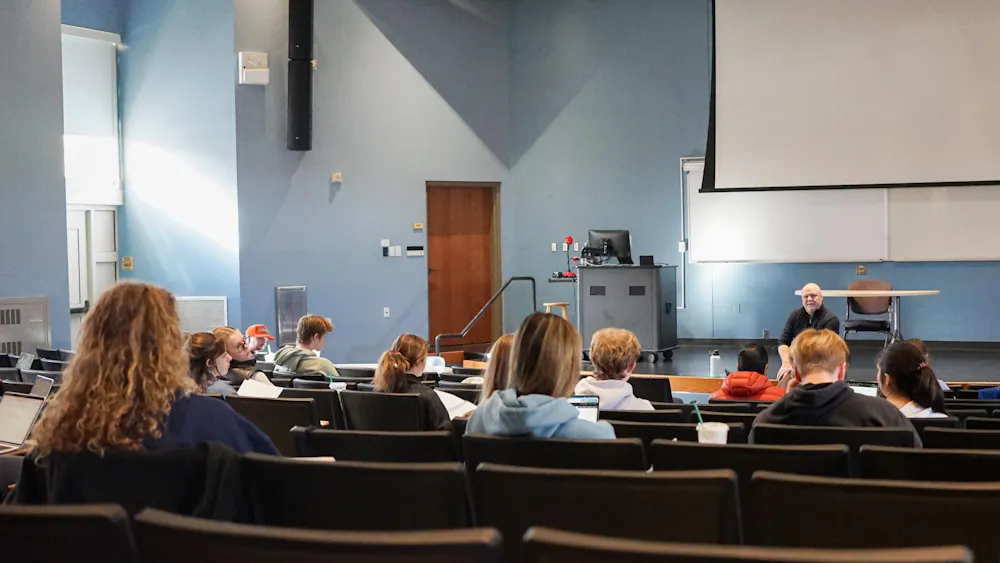 Students discuss their course material during intro to psychology (PSY111) with Dr. Peter Wessels.