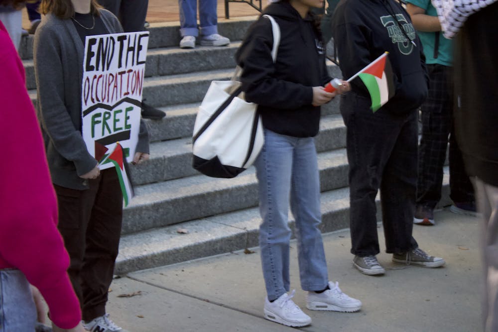 Marchers gathered outside Armstrong Student Center, waving Palestinian flags and holding signs calling for an end to violence against Palestinians. 
